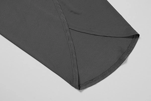 Detail of dark grey overlapping hemline with premium stitching on slim fit jumpsuit