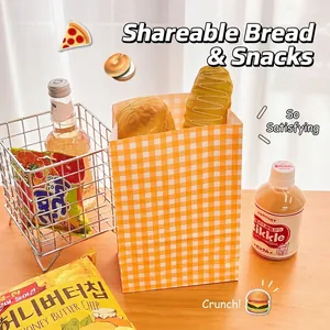 Yellow checkered paper gift bag on a wooden table for snacks and bakery packaging