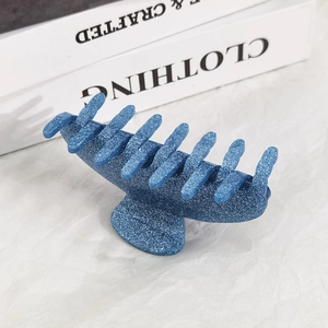 Detailed macro view of the blue glitter resin shark hair claw clip for women