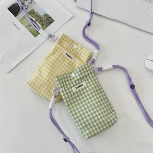 Détail de mini pochettes à carreaux jaune et vert avec cordons violets réglables