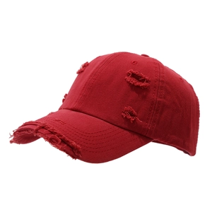 Distressed red cotton baseball cap with vintage ripped details and worn edge style