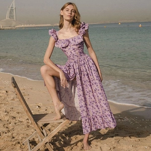 Detail of purple floral maxi dress featuring ruffles and a stylish side slit design