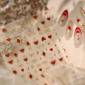 Y2K style red and gold nail stickers with heart, star, and bow designs for manicure