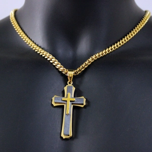 Mens gold Cuban chain necklace with layered gold and black cross pendant on a mannequin