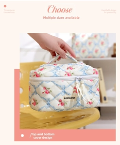 Detailed view of cream quilted makeup bag with pink floral and blue bow patterns