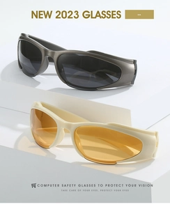 Close-up of stylish Y2K cycling sunglasses in charcoal grey and cream white frames