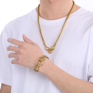 Detail view of a 6mm dragon bone chain set with dual lion head clasps on a male model