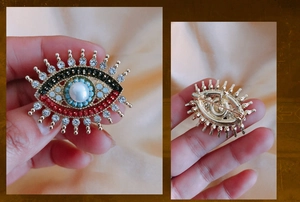 Detailed front and back view of evil eye brooch with freshwater pearl and rhinestones
