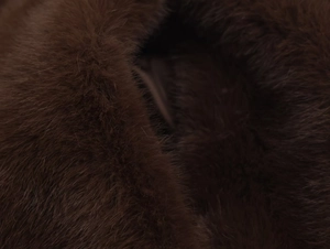 Close-up of high-density brown faux fur material showing soft and thick fiber textures
