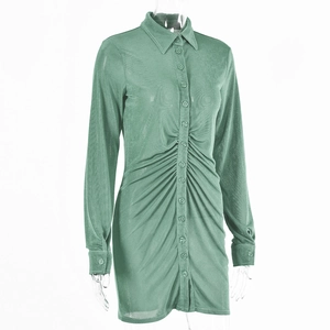 Detailed close-up of sage green shirt dress featuring ruched button front and pointed collar