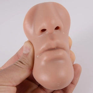 Silicone face model for lipstick piercing training showing soft texture and skin-like feel