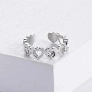 Macro view of silver heart shaped open ring with sparkling cubic zirconia inlay