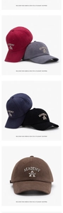 Detailed view of assorted embroidered cotton baseball caps in multiple solid colors
