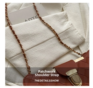 Detail shot of brown woven leather shoulder bag with gold clasp and chain strap