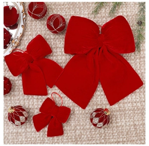 Detail view of red velvet Christmas bows in various sizes on a soft plush background