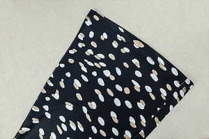 Detail of the high-quality stitching and polka dot print on the hem of the two-piece set