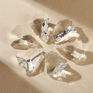 Faceted crystal glass pendants arranged in a ring showing detailed light and shadow effects