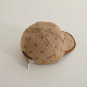 Macro view of khaki corduroy kids cap with bear prints and adjustable velcro strap