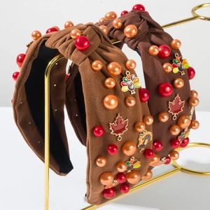 Detail of Thanksgiving knotted headbands with turkey charms, maple leaves, and pearls