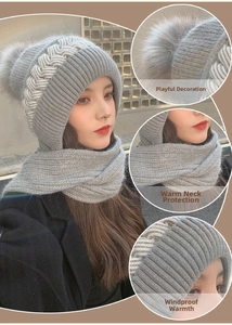 Detail of grey cable knit winter hooded scarf with large faux fur pompom and soft lining