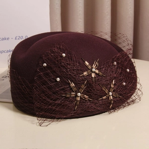 Deep burgundy wool felt pillbox hat with mesh veil and handcrafted pearl star details