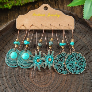 Bohemian vintage turquoise and bronze earring set featuring sun and disk pendant designs