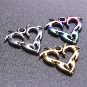 Detailed view of heart charms in silver, gold and rainbow finish with tribal pattern