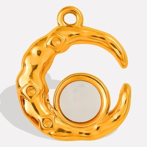 Detail showing gold hammered crescent pendant with white shell inlay and metal texture