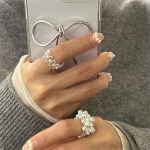 Detail shot of two S925 sterling silver rings with irregular hollow and beaded textures