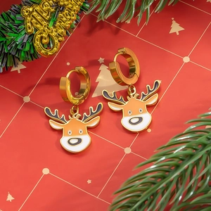 Detail of gold reindeer hoop earrings with enamel finish on festive red gift box