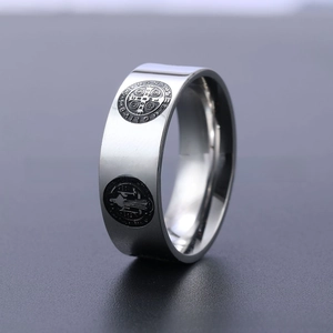 Macro shot of silver stainless steel band ring with St. Benedict religious emblem
