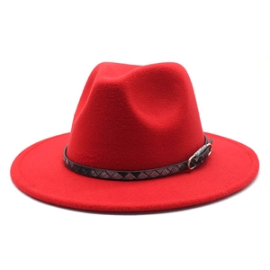 Detail of red wool felt fedora featuring a black woven band and golden metal buckle