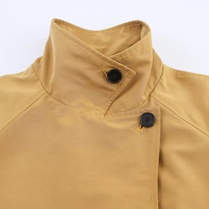 Short khaki trench coat for women featuring a minimalist lapel and button details