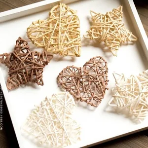 Close-up of handmade wicker stars and hearts in natural tones for festive decoration