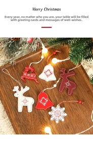Detail of wooden Christmas ornaments with reindeer and bell designs on a rustic tray