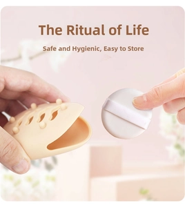 Detailed close-up of a nude silicone powder puff storage case with a white round makeup sponge