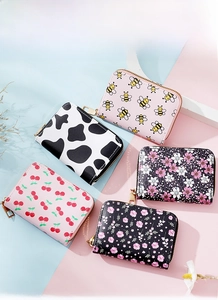 Flat lay view of five printed accordion card wallets with various floral and animal patterns