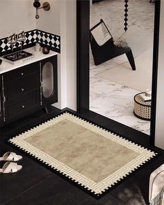 Close-up of French vintage entrance mat with khaki center and white geometric border