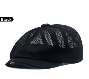 Detail of black mesh sun hat showing breathable fabric texture and solid brim