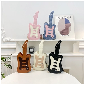 Detail of creative guitar-shaped crossbody bags in various colors with star rivets