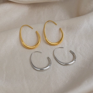 Minimalist U-shaped 18K gold and silver plated drop hoop earrings set on silk