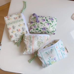 Detail of floral cotton mini pouches with simple wish tags and colorful wristlet straps