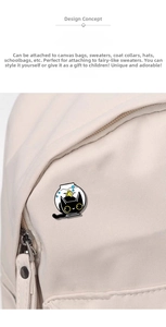 Detailed view of creative black cat fish tank enamel pin on a white canvas backpack