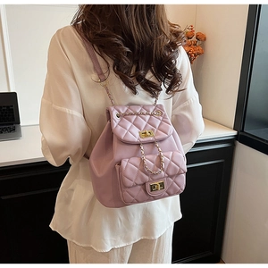 Detail of lavender quilted backpack with gold turn-lock and chain strap for women