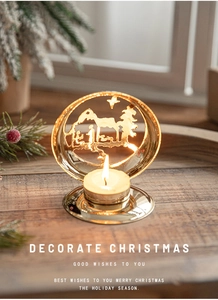Macro shot of golden Christmas candle holder with Nativity scene cutout and warm tealight
