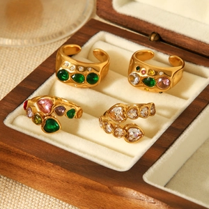 Detailed view of four 18k gold-plated open rings with colorful heart-shaped zircons