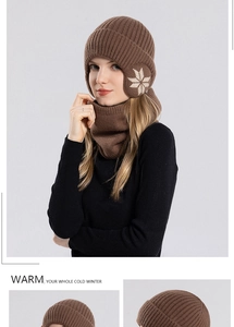 Detail of brown winter knit hat and neck warmer set with white snowflake pattern