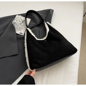 Detail of faux fur tote bag with black suede texture and white plush trim detailing