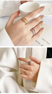 Detail of 18K gold plated minimalist rings on model holding coffee and book