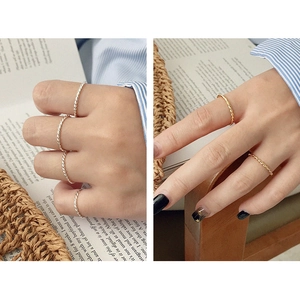 Close-up of S925 sterling silver twisted rope rings in gold and silver finishes